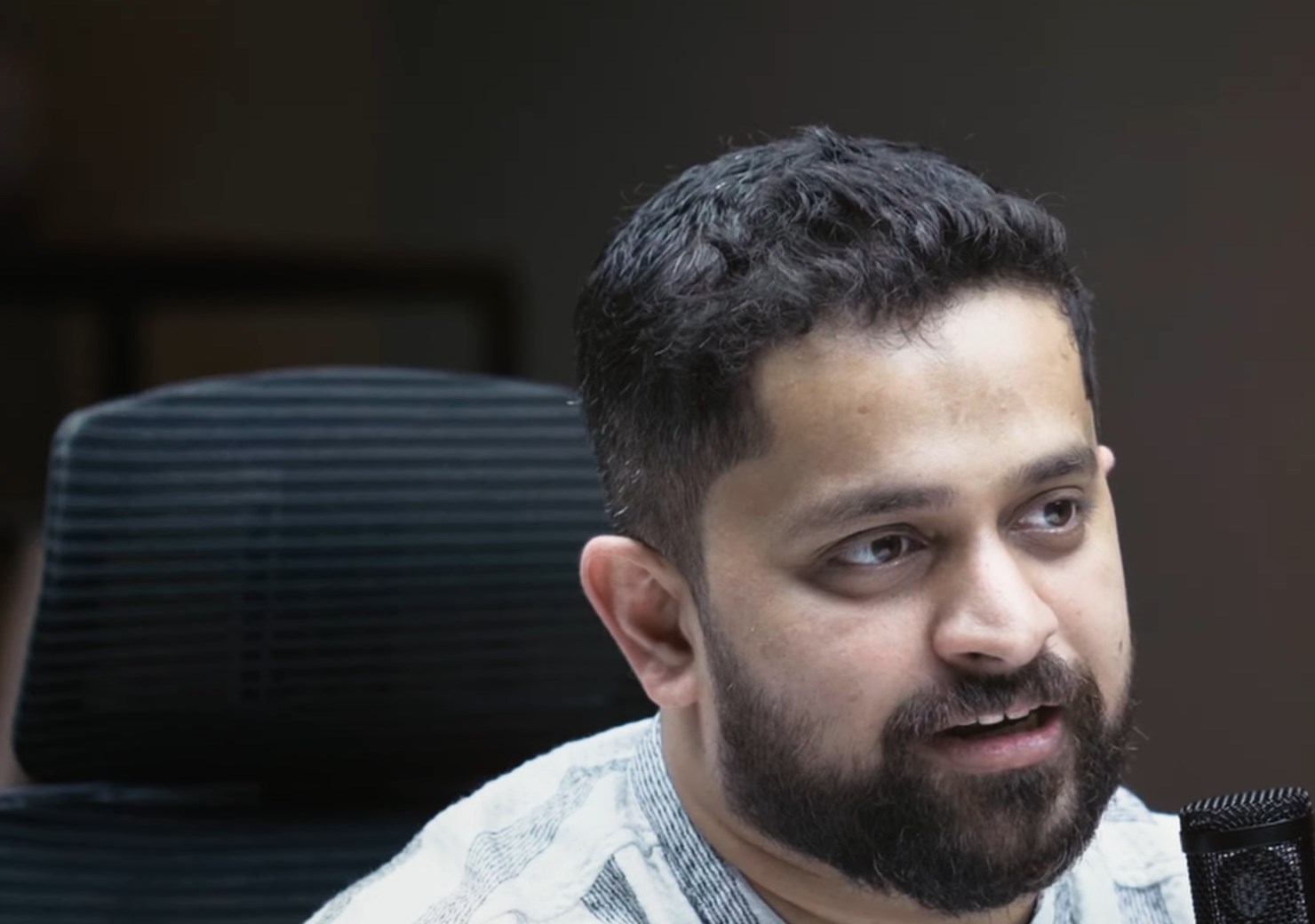 SOCIIUM founder Aravind Menon speaking in a professional studio